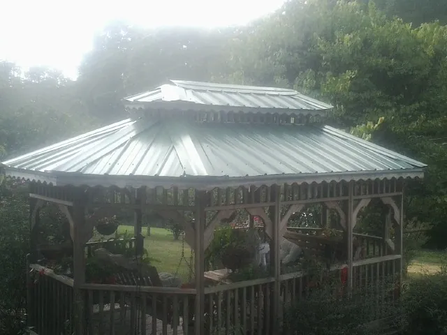 Two tier green metal roof on a garden gazebo in Wisconsin Dells